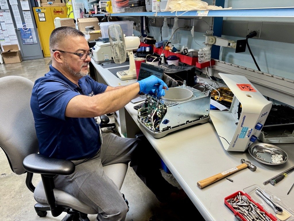 Biomedical technician servicing surgical equipment